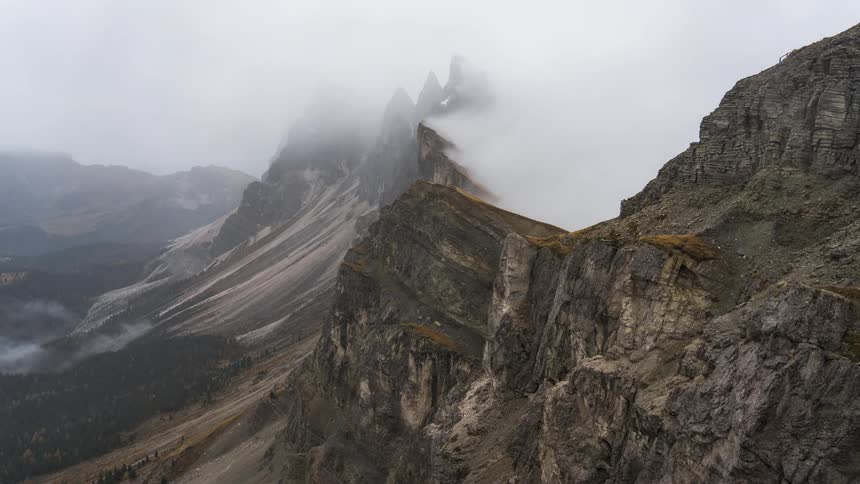 Mountainous landscape with rocky peaks and dense cloudy clouds