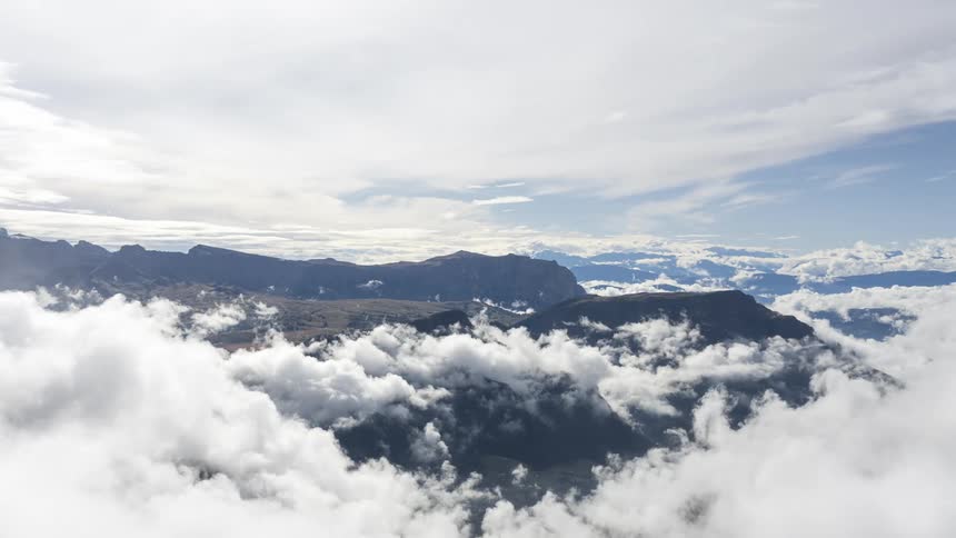Aerial view of mountains covered by a blanket of dense clouds