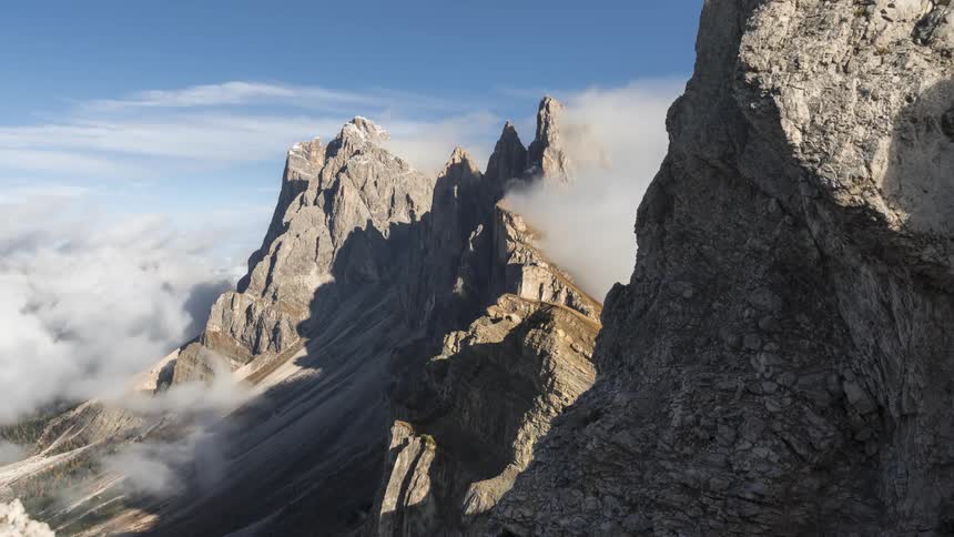 Thick clouds over the peak of a mountain