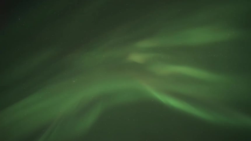 Aurora borealis swirls through the night sky