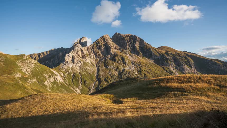 Mountainous landscape with a partly cloudy sky