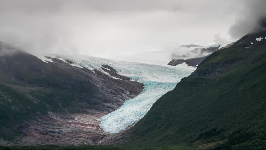 A frozen glacier located in a mountain valley