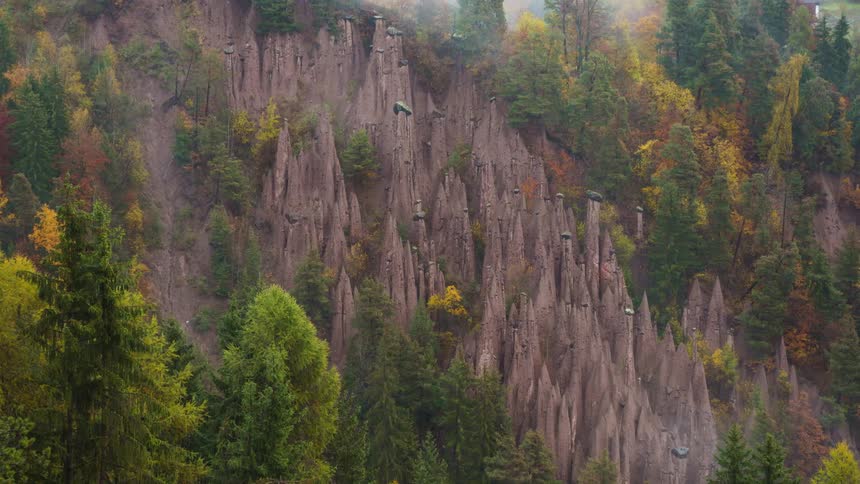 Tall narrow pillars of earth surrounded by autumnal forest
