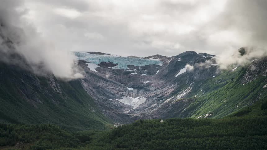 Heavy clouds flow on the mountain