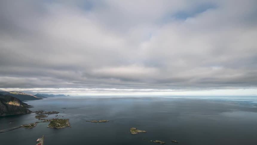 Dense clouds move over a coastal area and islands with communities living on them
