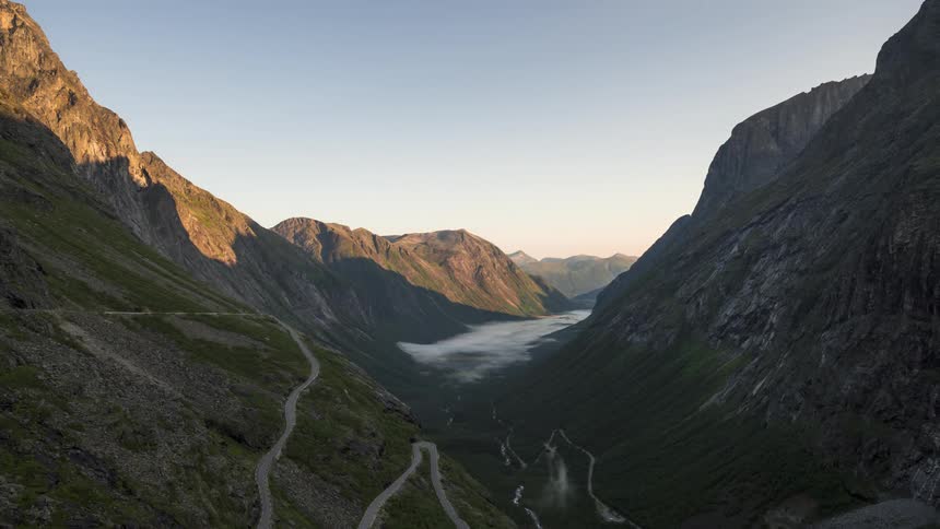 Mist flows over the valley