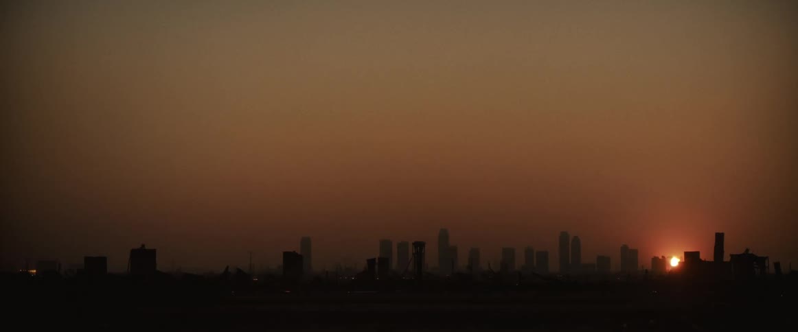 Silhouette of a metropolis with sunrise on the horizon
