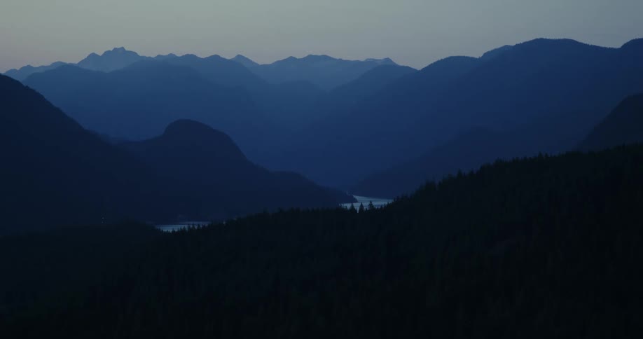 A mountain range and valley during the night time