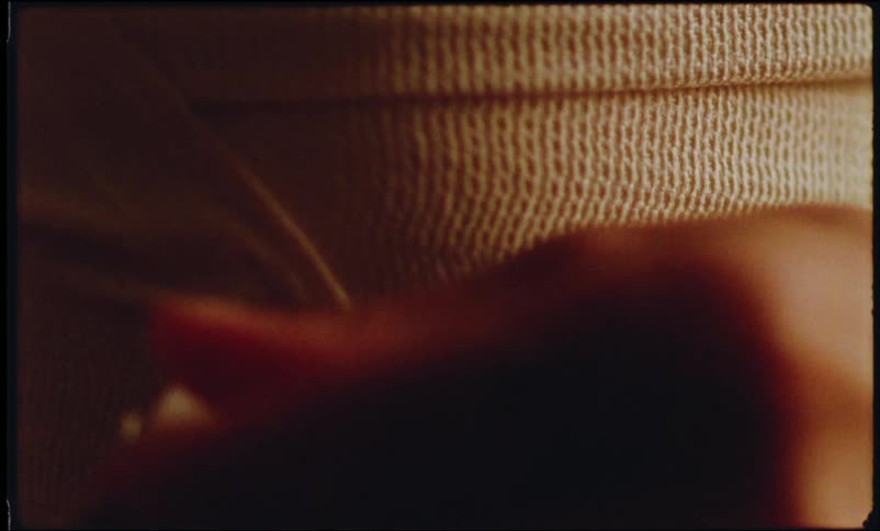 A patient slowly removes a bandage from their body