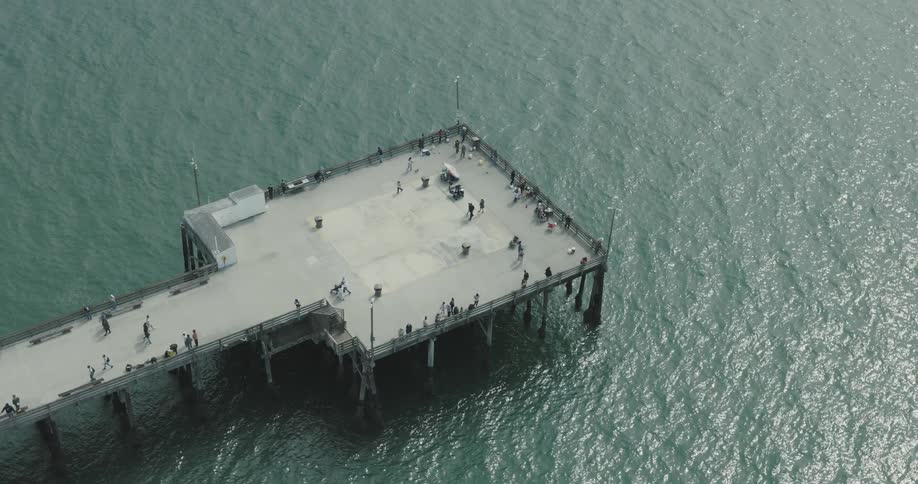 Aerial view of a pier extending into a body of water