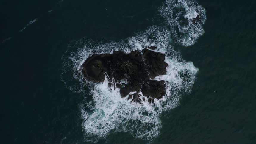 Aerial view of a rock formation in the middle of the ocean