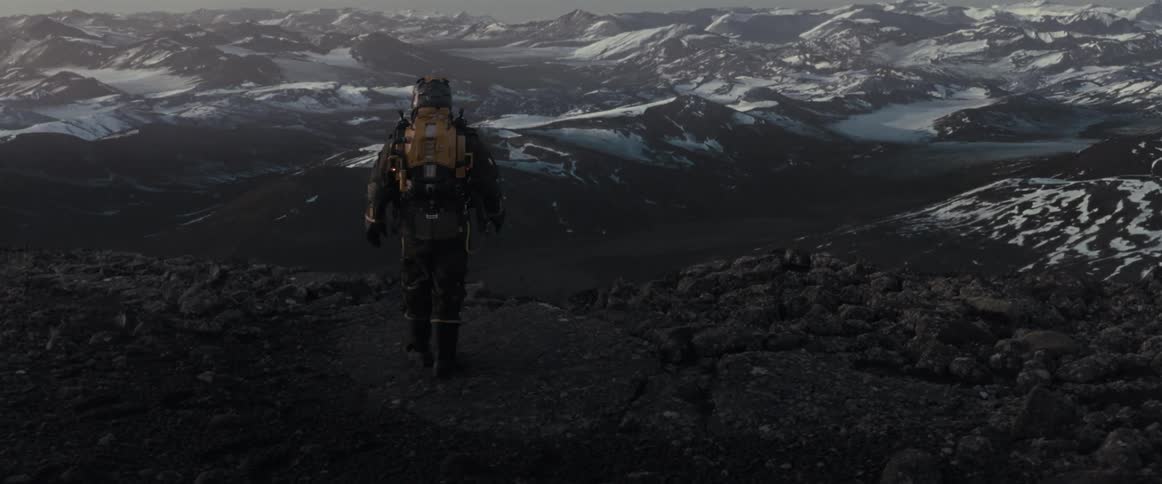 A man stops at the cliff of a mountain