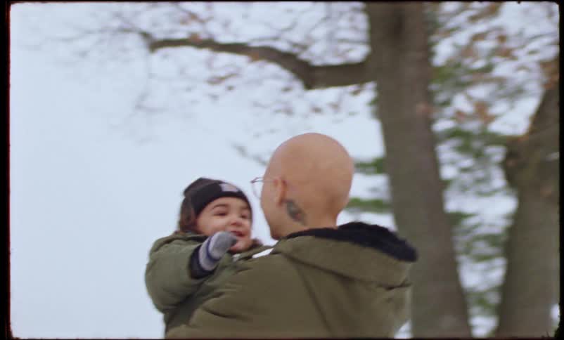 A mother holds her son outside