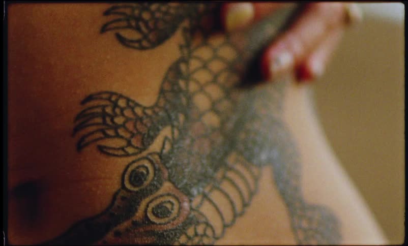 Close up of a person sliding his hand over the tattoos on their body