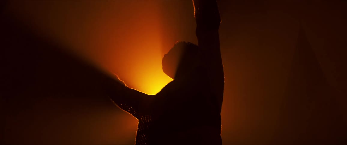 A man is dancing in the dark