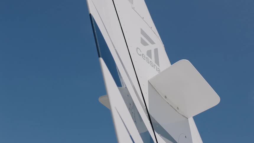 White of the tail of a cessna contrasts with the blue of the sky