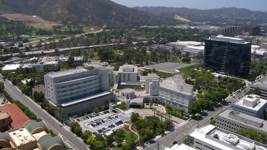 Aerial panorama of a metropolis and a hotel zone surrounded by mountains on the horizon