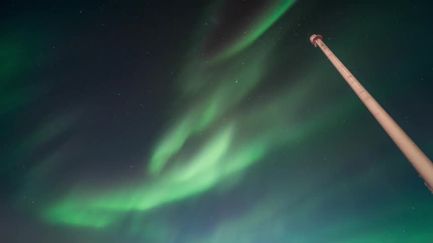 Arctic night sky with greenish northern lights