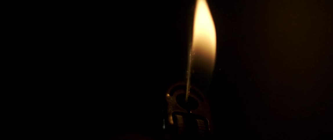 A lighter is ignited in slow motion