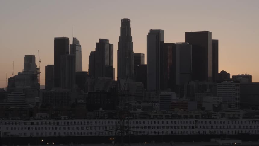 The sun setting over a city skyline