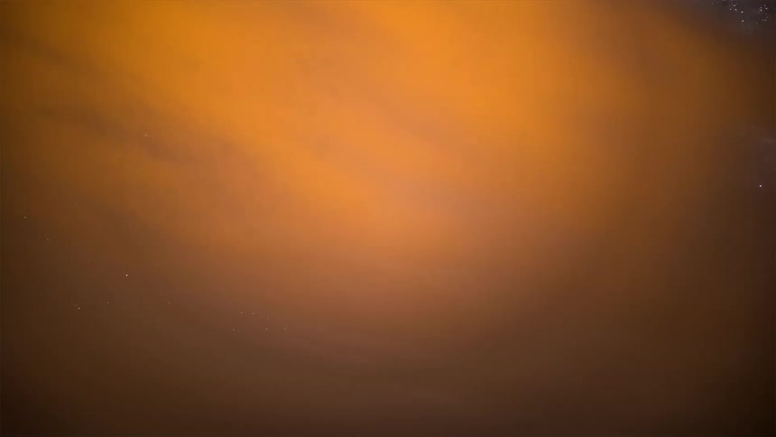 Clouds partially obscure space and then mountains and a landscape move into view