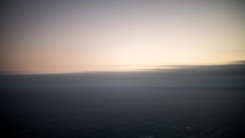 Wide view of the ocean water with sun reflecting from a sunset
