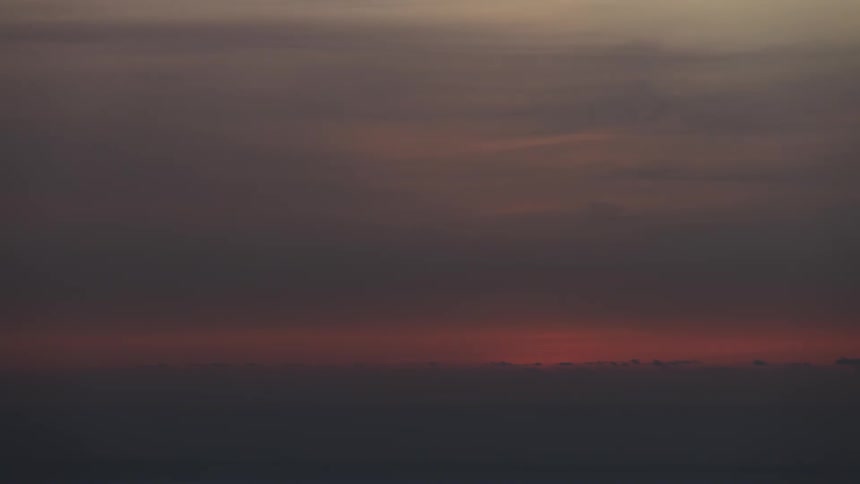 Sun setting over a horizon with dense clouds