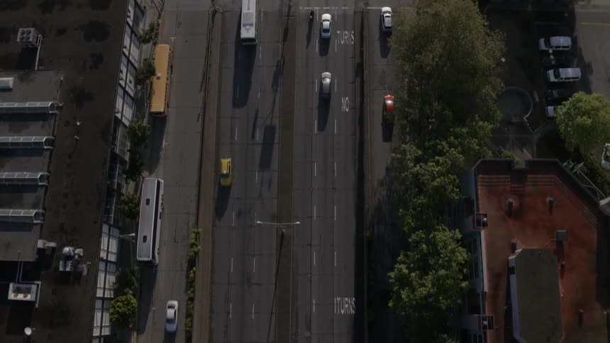 Cars drive along roads in a city