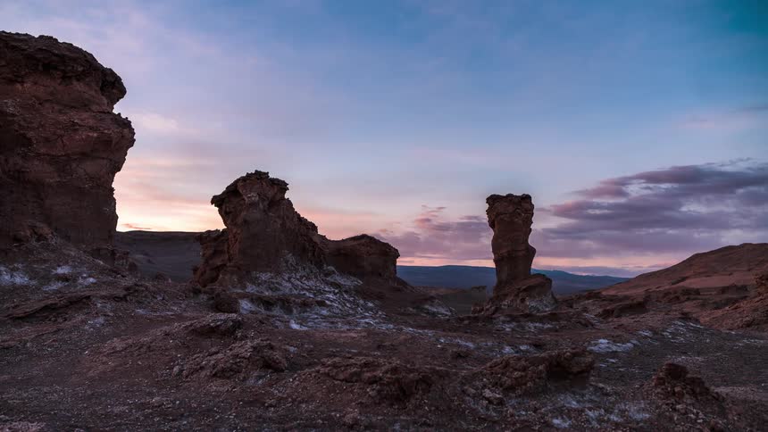 Time lapse of the sun setting in horizon of a canyon valley