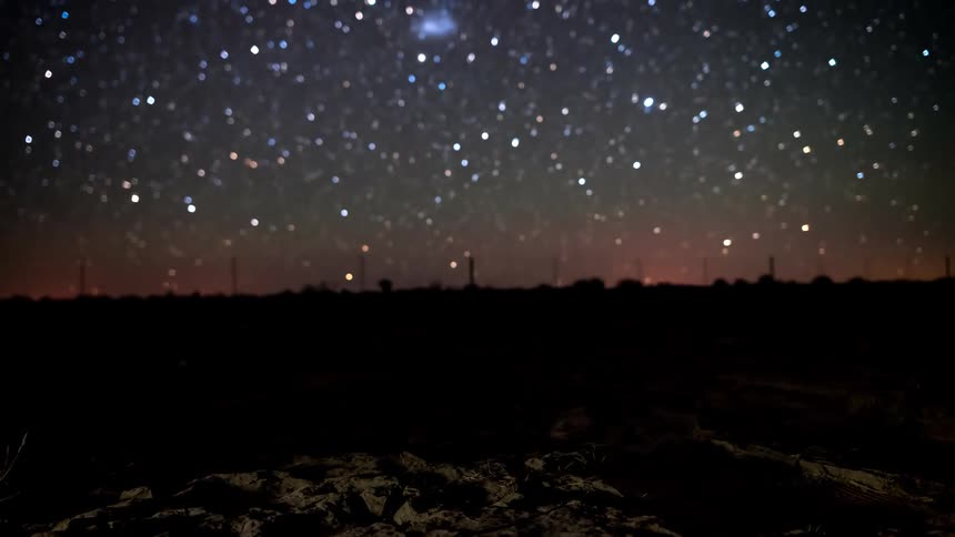 Rocky ground with sky with constellations and stars at night