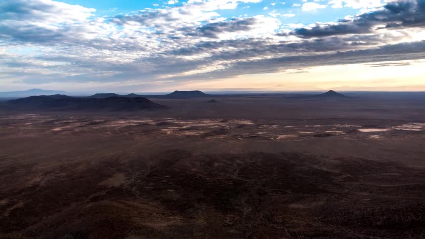 Cloudy sky above mountains with dusk