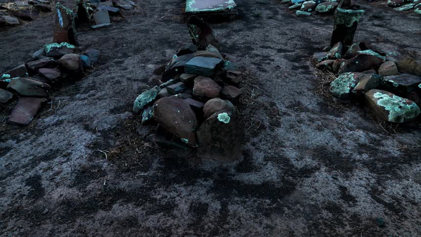 Rocks are stacked on the graves