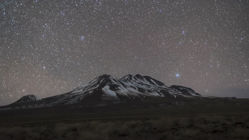 Landscape of a mountain covered in snow with a dusk and stars emerging