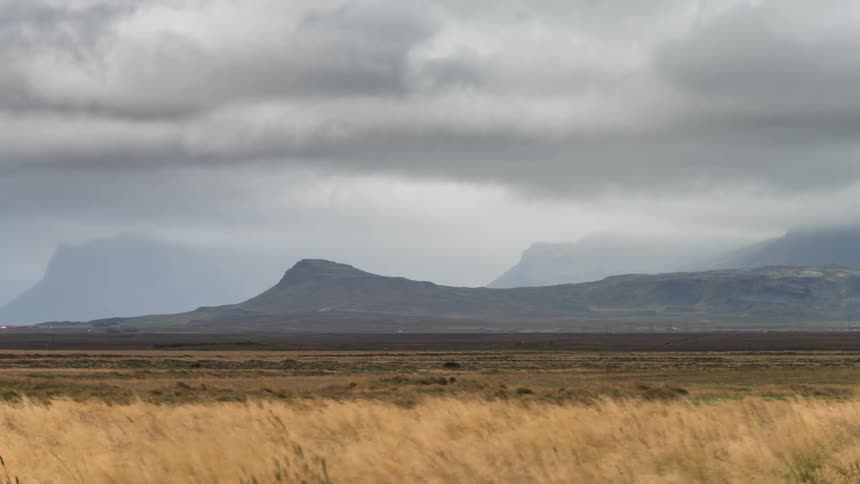 Mountain landscape with black stormy clouds passing by