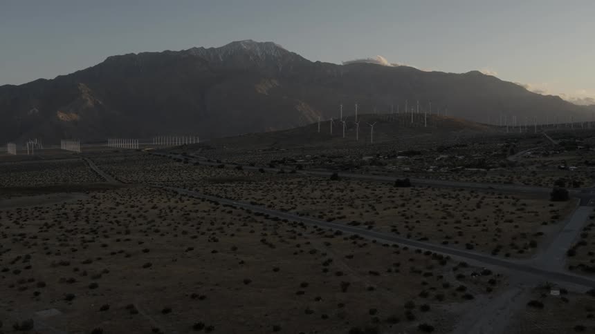 A large field below leads towards a mountain