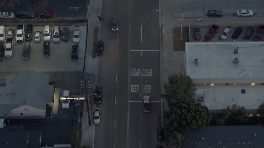 Cars driving down a city street