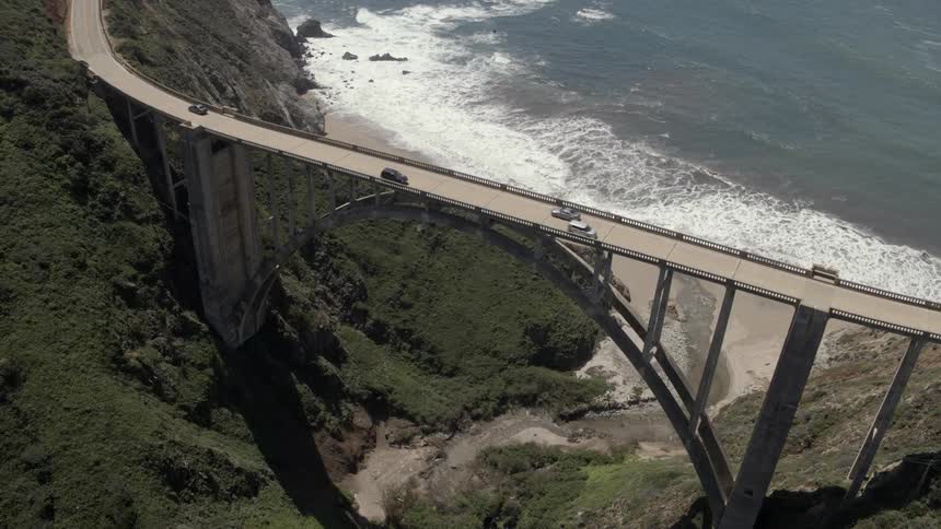 Traffic travels over bixby bridge along the coast