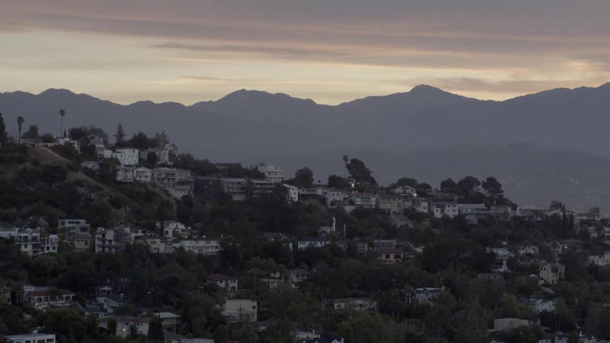 The sun is setting behind this hillside town