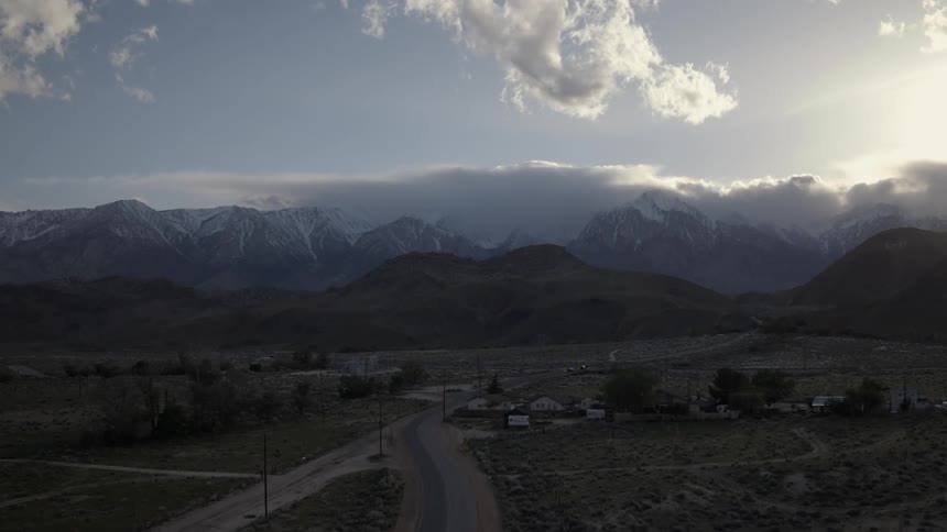 A view of the mountains in the distance with snow on the peaks
