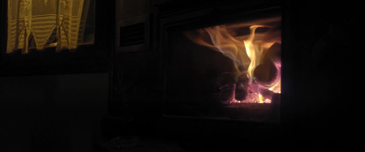 A fire burns in a fireplace