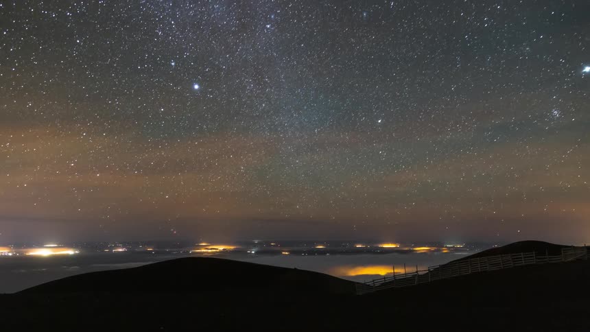 Panorama of mountains silhouette against a starry night sky