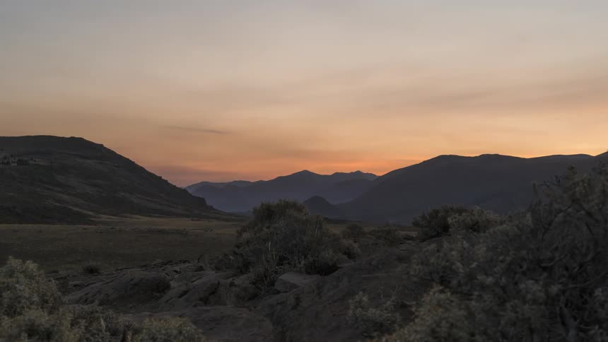 Mountain range and the sun setting on the horizon