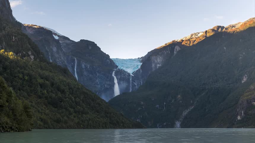 Natural landscape with a glacier in the background between mountains with waterfalls flowing into a lake