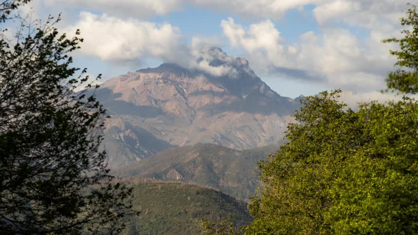 Time lapse of clouds rolling over a mountain top