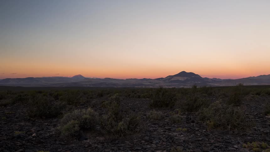 The sun is setting in the horizon of the grassland plains