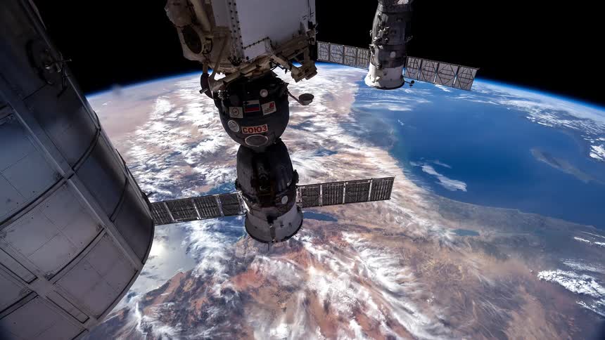 Soyuz spacecrafts docked at the international space station overlooking the earth