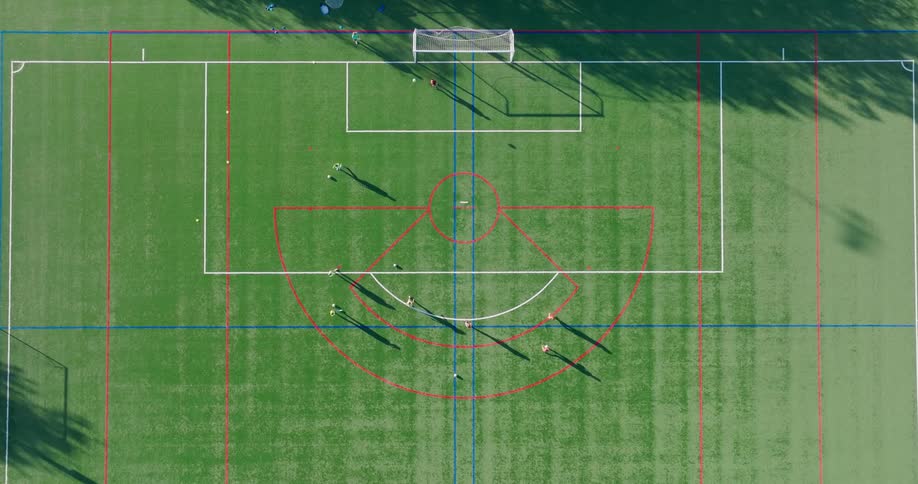 Teenage girls rotating positions while practicing soccer on a turf field