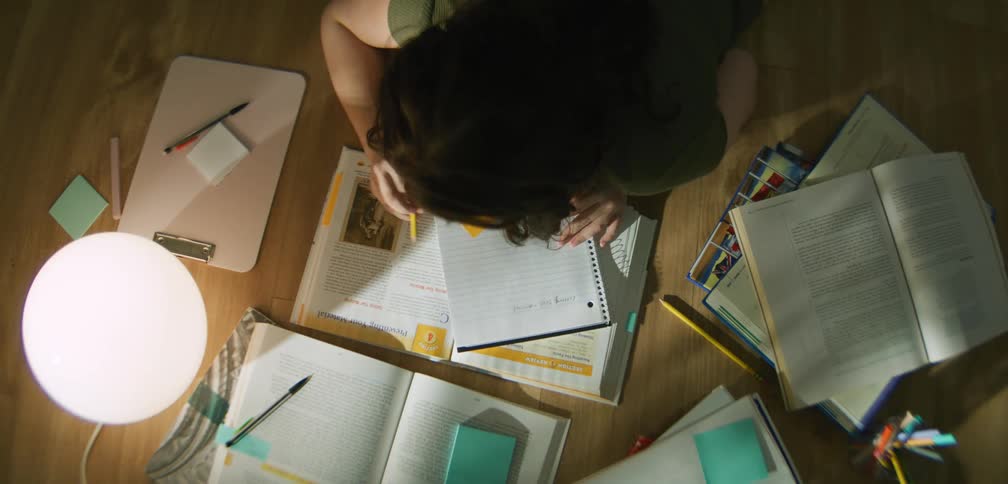 A girl is reading books and studying at a table