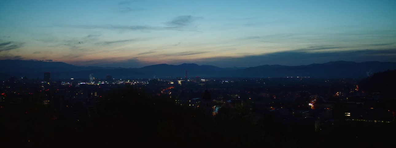 A downtown city in the horizon during the night time