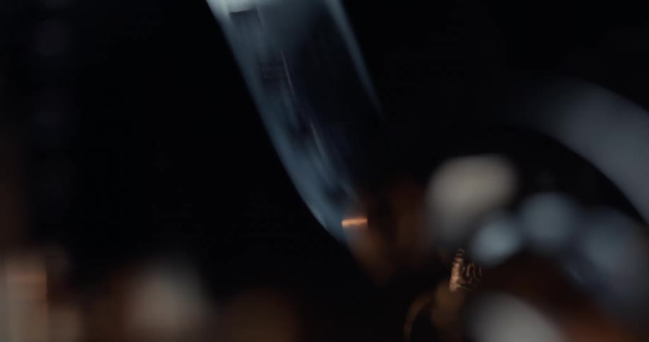 Film spooling as a machine spins with light behind it